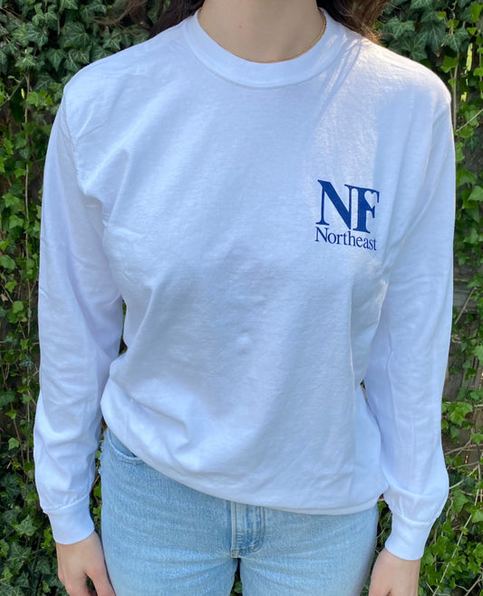 white long sleeve shirt on woman with NF Northeast logo printed on upper left chest in navy blue